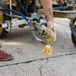 Hand holding the spray nozzle of machine